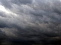 Dark gray heavy clouds in the sky before a thunderstorm. Natural gloomy sinister background. Dramatic spectacular backdrop or Royalty Free Stock Photo