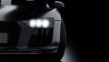 Dark gray modern sport car closeup on black background. Light on Royalty Free Stock Photo