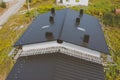 dark gray roof of an industrial building made of metal. Corrugat