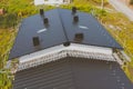 dark gray roof of an industrial building made of metal. Corrugat