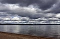 Dark grey sky over the calm lake