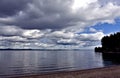 Dark grey sky over the calm lake