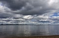 Dark grey sky over the calm lake