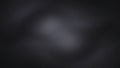 A dark gray textured background featuring a subtle light gray circular pattern in the center adding depth and visual interest to Royalty Free Stock Photo