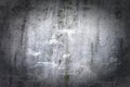 Dark gray wall in scratches and cracks. The texture of cracked paint and plaster. Background with vignette. Royalty Free Stock Photo