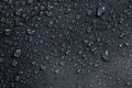 Dark gray waterproof hydrophobic cloth closeup with water drops selective focus background