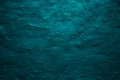 Dark green blue uneven texture. Painted old wall with plaster. Petrol color. Grunge surface background.