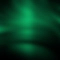 Dark green blurred gradient background with highlights. Cold shades.