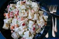 Dark green ceramic bowl filled with fresh potato salad