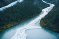 Dark green forest on banks of Iceland aerial river