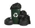 Dark green recycling bin overfilled with garbage bags on white background Royalty Free Stock Photo
