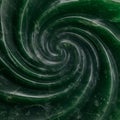 Dark green spiral pattern made of a smooth, polished stone, with a texture resembling Royalty Free Stock Photo