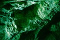 Dark green stone wall in a cave