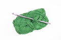 Dark green thread spool with purple crochet hook, isolated on white