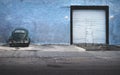 Dark green vintage Volkswagen beetle parking at abandoned blue building with garage gate, Merida, Yucatan, Mexico Royalty Free Stock Photo