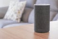Dark grey Amazon Alexa Echo in a living room on a wooden table. Empty copy space Royalty Free Stock Photo