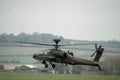 dark grey army attack helicopter in flight during the daytime