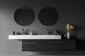 Dark grey bathroom wall with original vanity and round mirrors