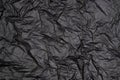 Dark grey or black crumpled paper background