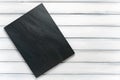Dark grey and black stone slate background or texture on white wood background table Royalty Free Stock Photo