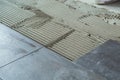 Ceramic floor tiles laid on applied adhesive Royalty Free Stock Photo