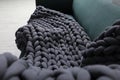 Dark grey chunky knit blanket on sofa indoors, closeup Royalty Free Stock Photo