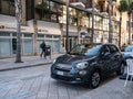 Dark grey Fiat 500X crossover parked in front of the restaurant at the street of Brindisi city