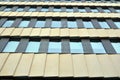 A view at a straight facade of a modern building with a dark grey facade.