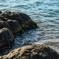 Dark Grey Rocks and Clear Ocean Water at the Coast Royalty Free Stock Photo