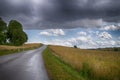 Country road running through open fields Royalty Free Stock Photo
