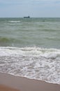 Dark grey stormy seascape with white sea foam on the waves