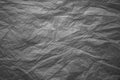 Dark grey crinkled paper texture.