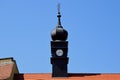 Dark grey zink cladded church clock tower. onion shaped segmented cupola