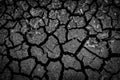 The dark ground is dried and cracks background. The black soil dry land cracked ground surface. landscape, poor soil Royalty Free Stock Photo