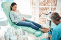 Beautiful woman patient on pedicure treatment with pediatrician chiropodist