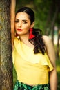 Dark hair woman portrait by the tree latino look Royalty Free Stock Photo