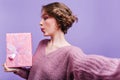 Dark-haired amazing girl making selfie on purple background with present. Studio shot of elegant brunette lady posing Royalty Free Stock Photo