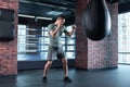 Dark-haired boxer feeling anger while training after losing competition