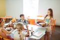 Dark-haired girl joining her friends in the school canteen