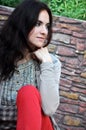 Dark-haired girl sitting on the bench Royalty Free Stock Photo