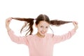 Dark-haired girl twitches his braids , close-up Royalty Free Stock Photo