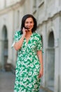 Dark-haired girl walks around the city and posing in a blue suit Royalty Free Stock Photo