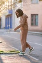 Dark-haired girl walks around the city and posing in a blue suit Royalty Free Stock Photo