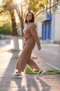 Dark-haired girl walks around the city and posing in a blue suit Royalty Free Stock Photo