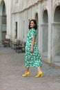 Dark-haired girl walks around the city and posing in a blue suit Royalty Free Stock Photo