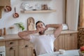 Dark-haired handsome man sitting at the table and yawning, feeling sleepy