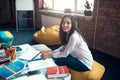 Dark-haired postgraduate student felling busy while preparing for exams