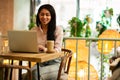 Dark haired student in casual clothes working on her laptop Royalty Free Stock Photo