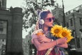 Dark-haired student feeling pleased after receiving sunflowers from boyfriend