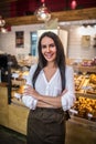 Dark-haired successful businesswoman opening French bakery